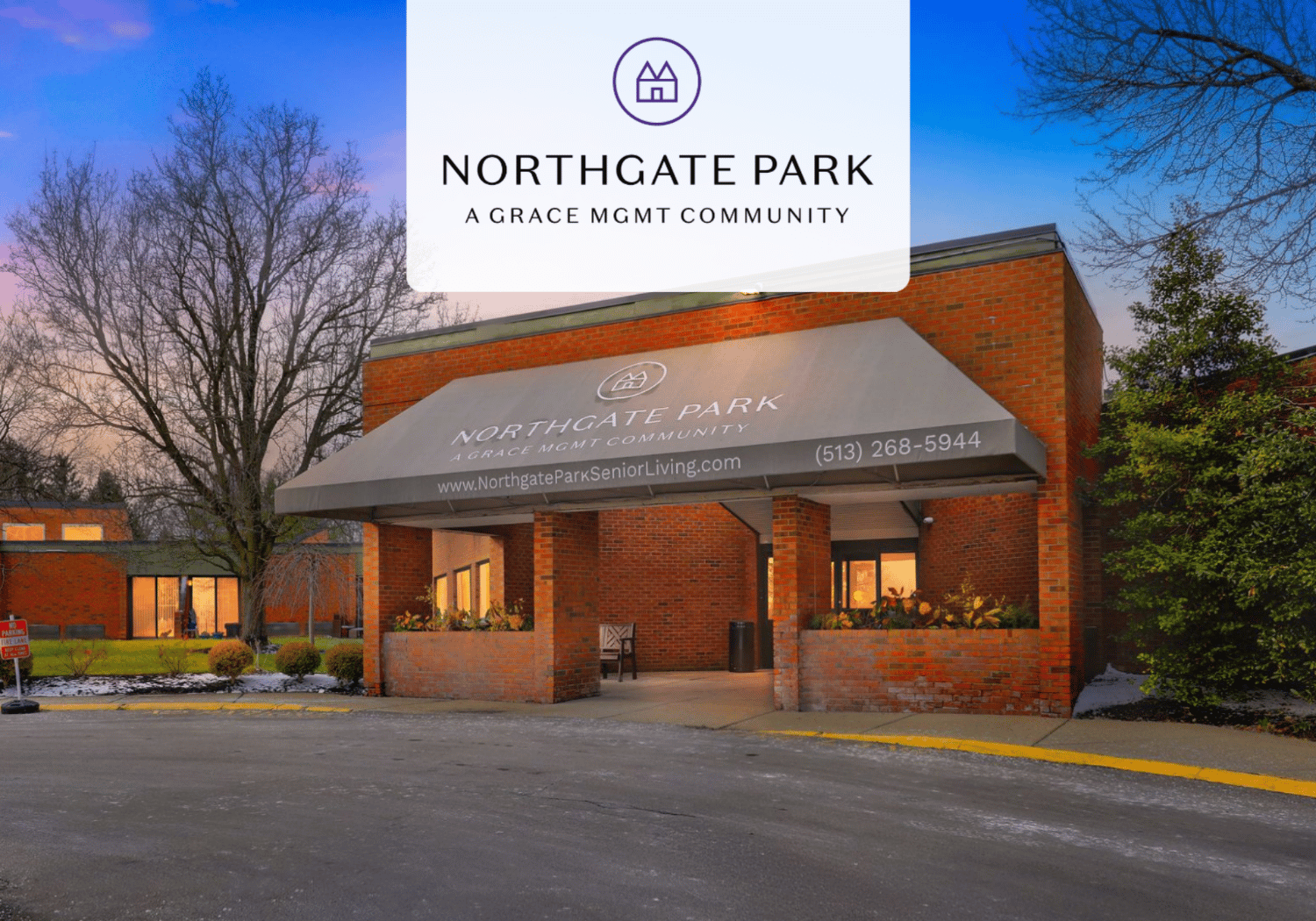 Front entrance of Northgate Park Senior Living, a brick building with a large awning reading 'Northgate Park Senior Living' and planters nearby